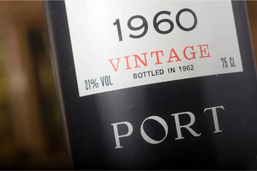 Close-up of a dark port bottle labeled 1960 vintage, bottled in 1962, 21 percent alcohol, 75 cl