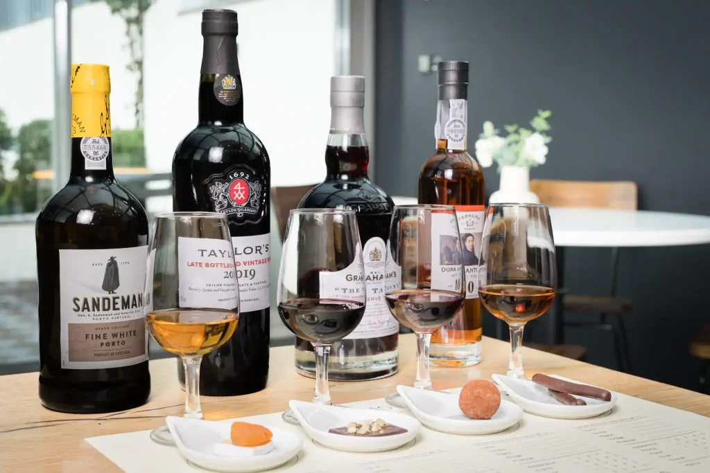 Sandeman, Taylor's and Graham's Port bottles with tasting glasses and chocolate pairings